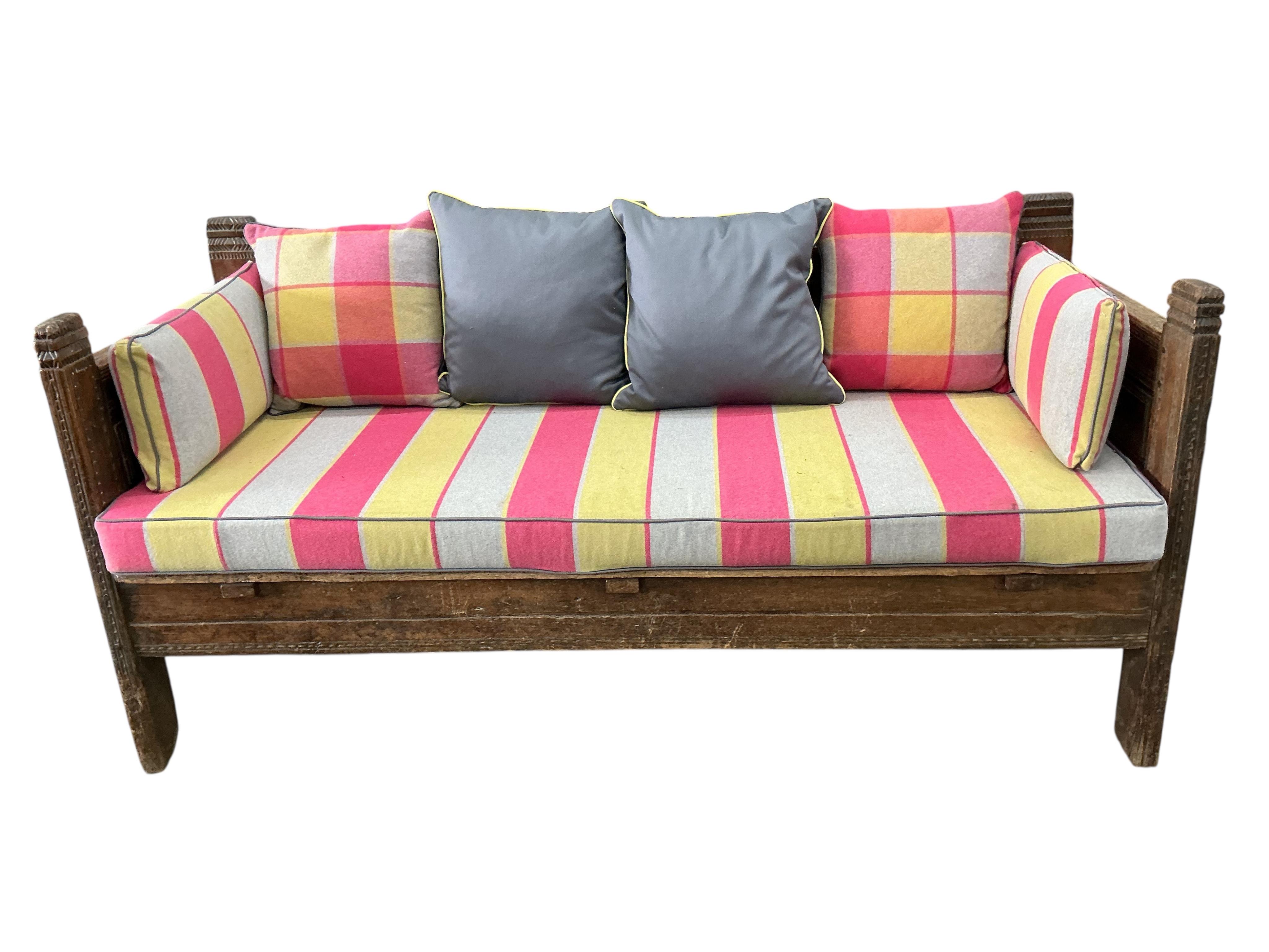 A 19th century Continental hardwood settee with upholstered cushions, width 190cm, depth 76cm, height 89cm, Provenance: The late Kenneth Turner (1936-2025), celebrity florist, designer and perfume retailer, he received t